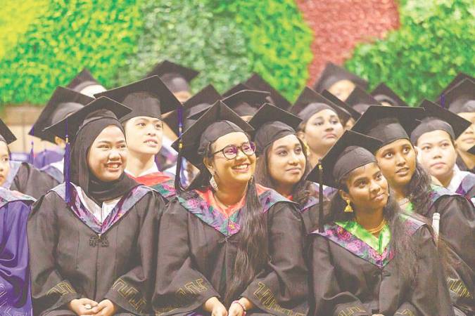 Graduates of the VTOC programme, front row (from left), Nurul, Shalini Subramaniam and Praveena beaming with pride, at the 26th graduation ceremony.