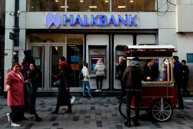 FILE PHOTO: People walk past a branch of Halkbank in central Istanbul, Turkey, January 22, 2020. -REUTERSpix